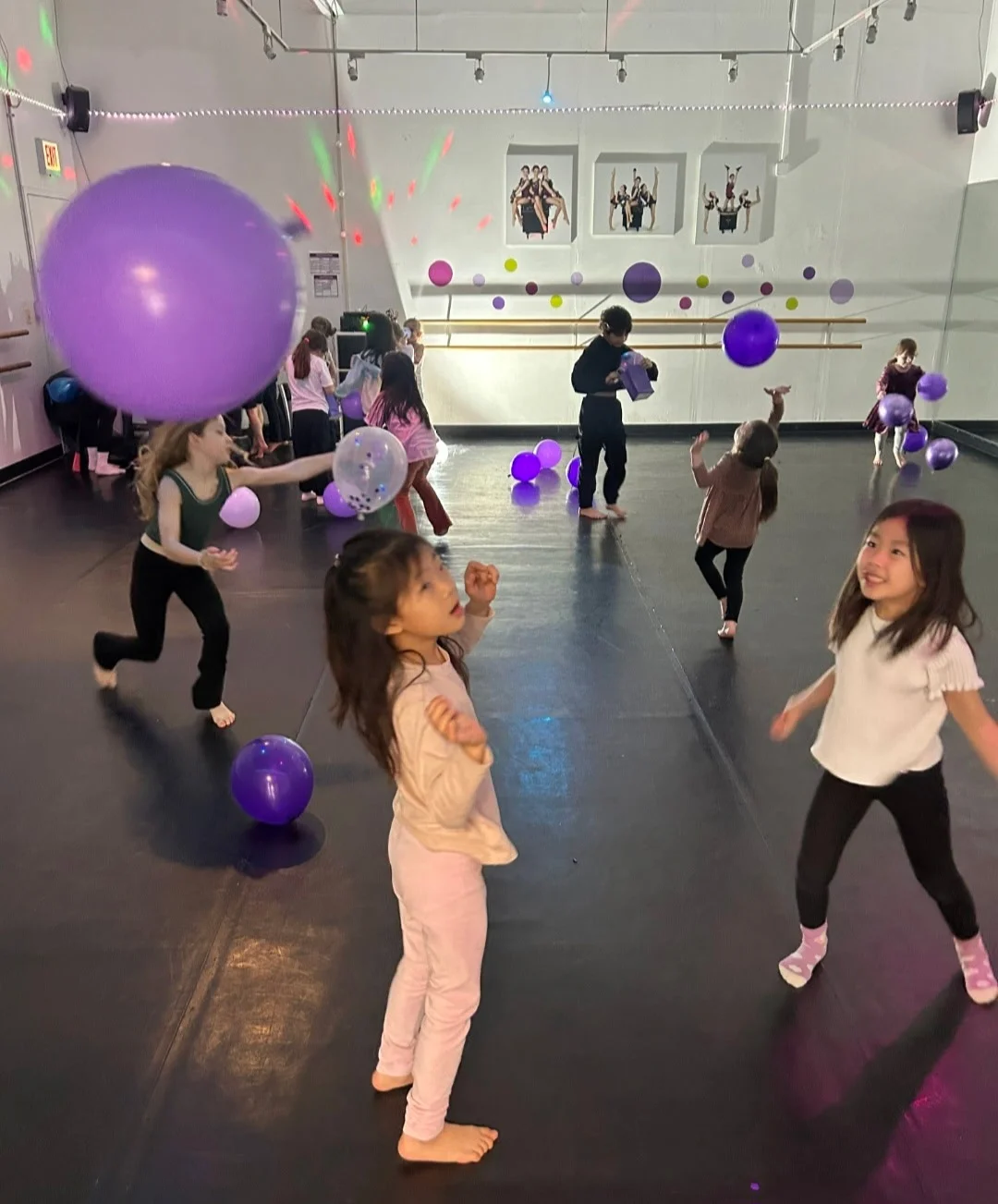 Children moving and playing with balloons during a Dance Jam event